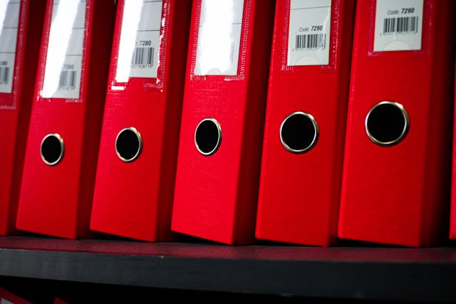 red-office-binders-on-shelf-in-close-up-view